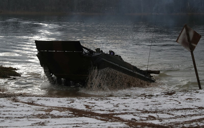 Polish Infantry fighting vehicle BWP crosses the lake during TUMAK-22 NATO exercises in an area known as the Suwalki Gap, of crucial significance to the security of the alliance's eastern flank, at a polygon in Klusy, Poland November 25, 2022. REUTERS/Kacper Pempel