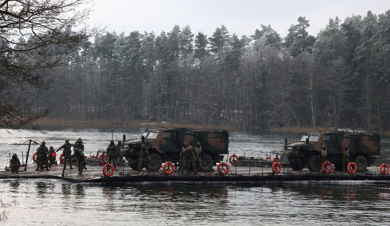 Polish Infantry fighting vehicle BWP crosses the lake during TUMAK-22 NATO exercises in an area known as the Suwalki Gap, of crucial significance to the security of the alliance's eastern flank, at a polygon in Klusy, Poland November 25, 2022. REUTERS/Kacper Pempel