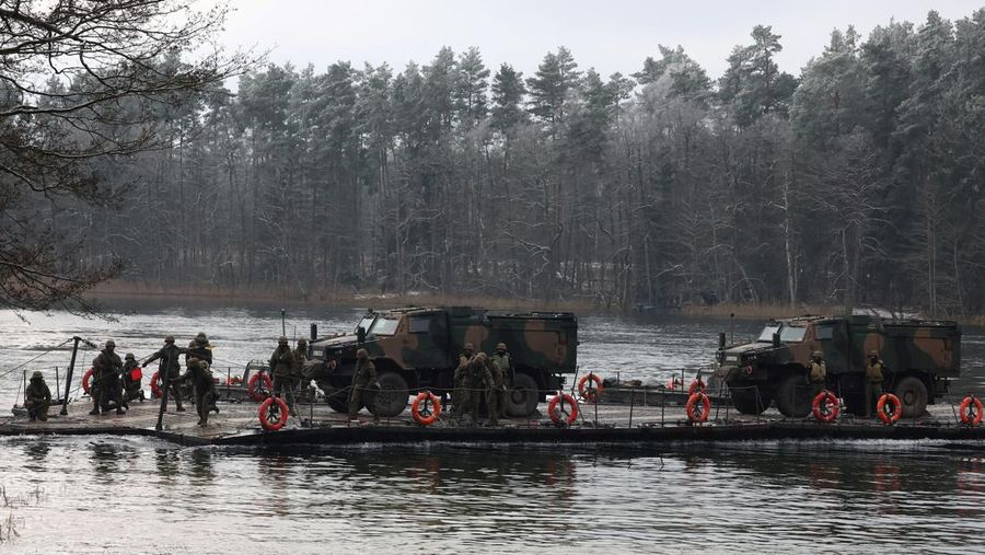 Polish military vehicles are transported during TUMAK-22 NATO exercises in an area known as the Suwalki Gap, of crucial significance to the security of the alliance's eastern flank, at a polygon in Klusy, Poland November 25, 2022. REUTERS/Kacper Pempel