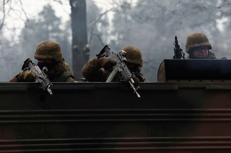 Polish Infantry fighting vehicle BWP crosses the lake during TUMAK-22 NATO exercises in an area known as the Suwalki Gap, of crucial significance to the security of the alliance's eastern flank, at a polygon in Klusy, Poland November 25, 2022. REUTERS/Kacper Pempel