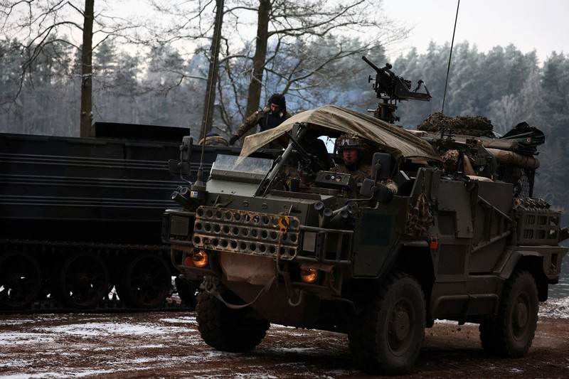 Polish Infantry fighting vehicle BWP crosses the lake during TUMAK-22 NATO exercises in an area known as the Suwalki Gap, of crucial significance to the security of the alliance's eastern flank, at a polygon in Klusy, Poland November 25, 2022. REUTERS/Kacper Pempel