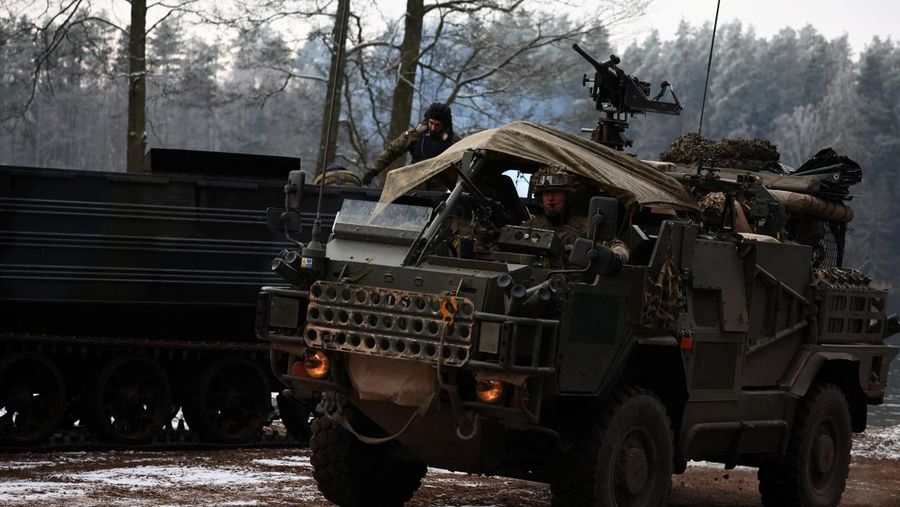 Polish Infantry fighting vehicle BWP crosses the lake during TUMAK-22 NATO exercises in an area known as the Suwalki Gap, of crucial significance to the security of the alliance's eastern flank, at a polygon in Klusy, Poland November 25, 2022. REUTERS/Kacper Pempel