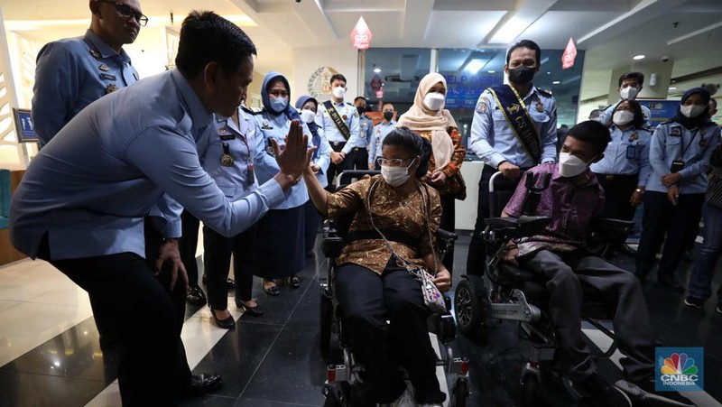 Petugas melayani warga berkebutuhan khusus  (disabilitas) dalam acara Pembukaan Pekan Layanan Keimigrasian Ramah HAM dalam rangka Peringatan Hari HAM Sedunia ke-74 Tahun 2022 di Kantor Imigrasi Kelas I Khusus Non TPI, Jakarta, Senin (28/11/2022). (CNBC Indonesia/Tri Susilo)