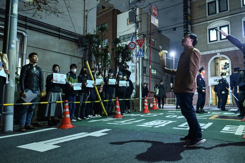 A group of protesters hold a peaceful gathering down the street from the Chinese embassy in Tokyo on November 28, 2022, in support of demonstrations held in China over Beijing's Covid-19 restrictions. - Hundreds of people have taken to the streets in China's major cities in a rare outpouring of public anger against the state over its zero-Covid policy. (Photo by Richard A. Brooks / AFP) (Photo by RICHARD A. BROOKS/AFP via Getty Images)