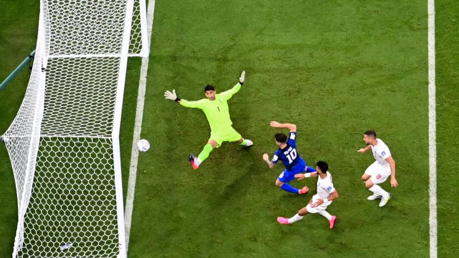 Penyerang AS, Christian Pulisic mencetak gol pertama timnya saat melewati kiper Iran, Alireza Beiranvand selama pertandingan sepak bola Grup B Piala Dunia Qatar 2022 antara Iran dan AS di Stadion Al-Thumama di Doha, Selasa (29/11/2022). Amerika Serikat mengalahkan Iran 1-0 di laga terakhir Grup B Piala Dunia 2022. Hasil ini membawa The Yanks melaju ke 16 besar. (Photo by ODD ANDERSEN/AFP via Getty Images)