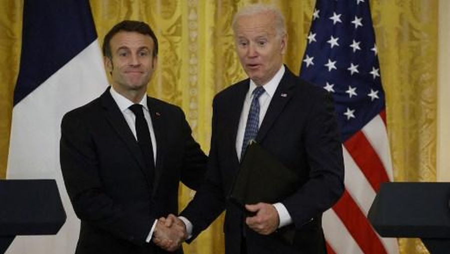 US President Joe Biden and French President Emmanuel Macron shake hands after a joint press conference in the East Room of the White House in Washington, DC, on December 1, 2022. (Photo by Ludovic MARIN / AFP)