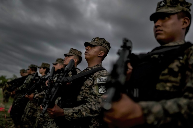 23 November 2022, El Salvador, San Juan Opico: Soldiers stand in formation while listening to President Bukele announce the fifth phase of the government's security policy against gangs. The Salvadoran government announced the fifth phase of its territorial control plan, which consists of militarily securing parts of cities. El Salvador has been under a state of emergency for eight months, as a result of which more than 57,000 suspected criminals have been arrested. Photo: Camilo Freedman/dpa (Photo by Camilo Freedman/picture alliance via Getty Images)