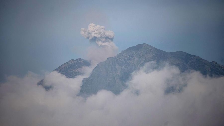 Smoke rises from Mount Semeru in Lumajang on December 5, 2022. - Indonesia's Mount Semeru erupted on December 4 spewing hot ash clouds a mile high and rivers of lava down its side while sparking the evacuation of nearly 2,000 people exactly one year after its last major eruption killed dozens. (Photo by JUNI KRISWANTO / AFP) (Photo by JUNI KRISWANTO/AFP via Getty Images)