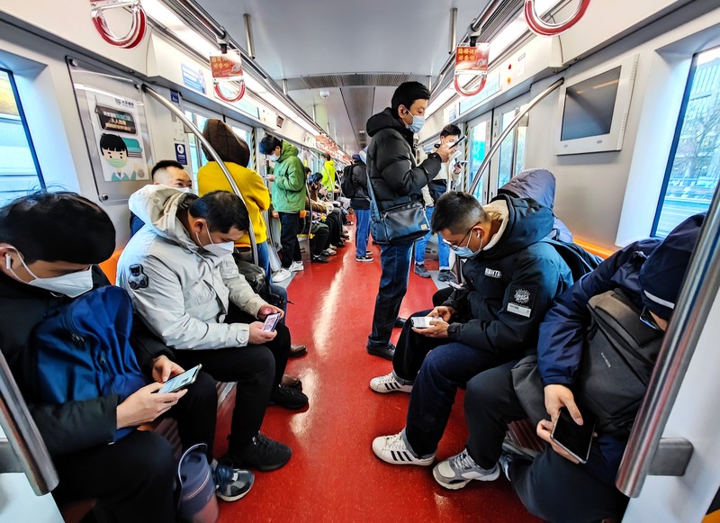 BEIJING, CHIAN - DECEMBER 5, 2022 - A light passenger flow is seen during the morning rush hour on Metro Line 5 in Beijing, China, December 5, 2022. On the same day, Beijing cancelled nucleic acid inspection on buses and subways. (Photo credit should read CFOTO/Future Publishing via Getty Images)