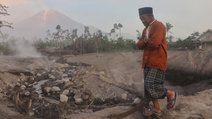 1245371731 LUMAJANG, INDONESIA - DECEMBER 5: An elderly man walks as Mount Semeru continues to spew volcanic ash after its eruption yesterday in Lumajang Regency, Indonesia on December 5, 2022. According to data from the Regional Disaster Management Agency (BPBD) Jawa Timur, at least 2.219 people fled after the eruption of Mount Semeru that occurred yesterday. (Photo by Suryanto/Anadolu Agency via Getty Images)