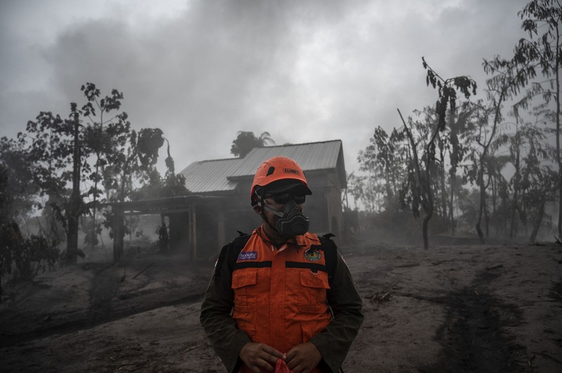 Anggota tim SAR memeriksa situasi di Desa Kajar Kuning, Lumajang pada 5 Desember 2022. Anggota tim SAR memeriksa situasi di Desa Kajar Kuning, Lumajang pada 5 Desember 2022. (JUNI KRISWANTO/AFP via Getty Images)