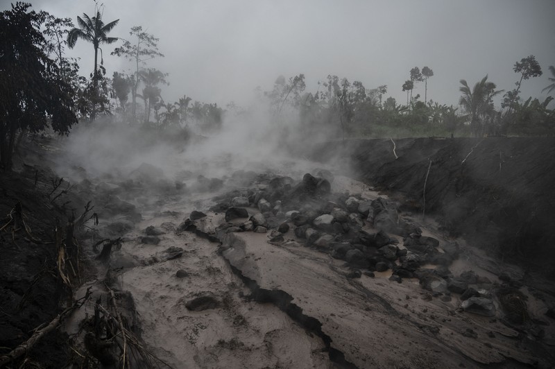 Anggota tim SAR memeriksa situasi di Desa Kajar Kuning, Lumajang pada 5 Desember 2022. Anggota tim SAR memeriksa situasi di Desa Kajar Kuning, Lumajang pada 5 Desember 2022. (JUNI KRISWANTO/AFP via Getty Images)