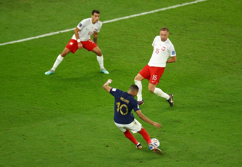 Soccer Football - FIFA World Cup Qatar 2022 - Round of 16 - France v Poland - Al Thumama Stadium, Doha, Qatar - December 4, 2022 France's Kylian Mbappe in action with Poland's Matty Cash REUTERS/Dylan Martinez     TPX IMAGES OF THE DAY