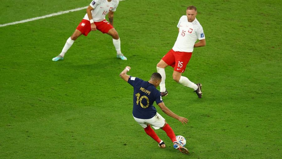 Soccer Football - FIFA World Cup Qatar 2022 - Round of 16 - France v Poland - Al Thumama Stadium, Doha, Qatar - December 4, 2022 France's Kylian Mbappe in action with Poland's Matty Cash REUTERS/Dylan Martinez     TPX IMAGES OF THE DAY