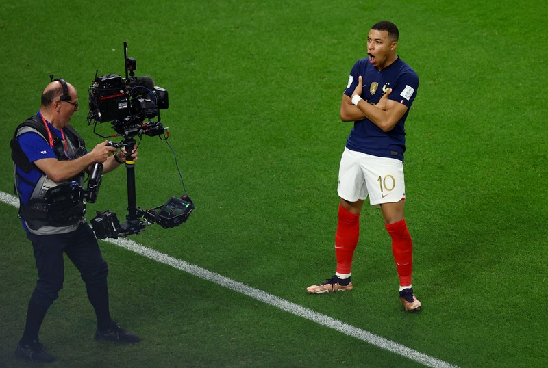 Soccer Football - FIFA World Cup Qatar 2022 - Round of 16 - France v Poland - Al Thumama Stadium, Doha, Qatar - December 4, 2022 France's Kylian Mbappe in action with Poland's Matty Cash REUTERS/Dylan Martinez     TPX IMAGES OF THE DAY