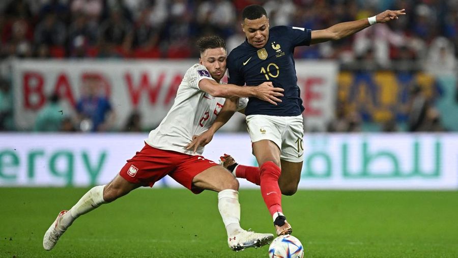 Soccer Football - FIFA World Cup Qatar 2022 - Round of 16 - France v Poland - Al Thumama Stadium, Doha, Qatar - December 4, 2022 France's Kylian Mbappe in action with Poland's Matty Cash REUTERS/Dylan Martinez TPX IMAGES OF THE DAY