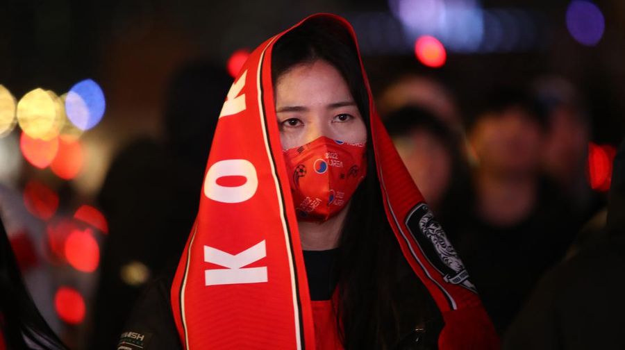 AL WAKRAH, QATAR - DECEMBER 05: A Japanese fan uses his sponge nose to dab tears from his eyes during the FIFA World Cup Qatar 2022 Round of 16 match between Japan and Croatia at Al Janoub Stadium on December 5, 2022 in Al Wakrah, Qatar. (Photo by Charlotte Wilson/Offside/Offside via Getty Images)