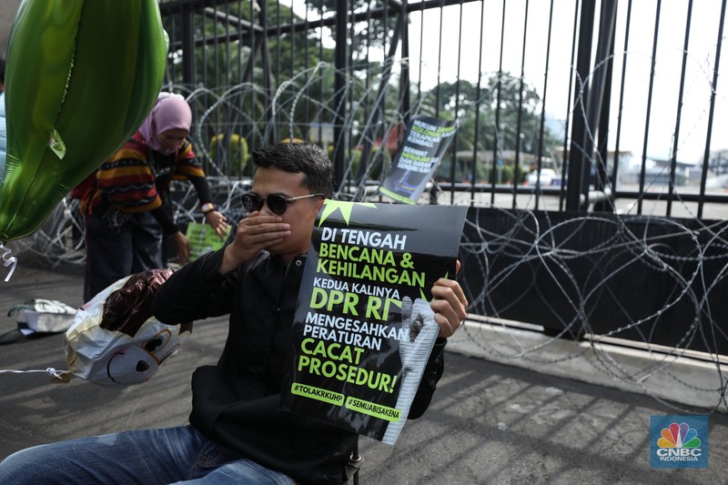 Sejumlah massa dari koalisi masyarakat sipil melakukan aksi tolak pengesahan Rancangan Kitab Undang-Undang Hukum Pidana (RKUHP) di depan gedung DPR RI, Jakarta, Selasa (6/12/2022). (CNBC Indonesia/Tri Susilo)