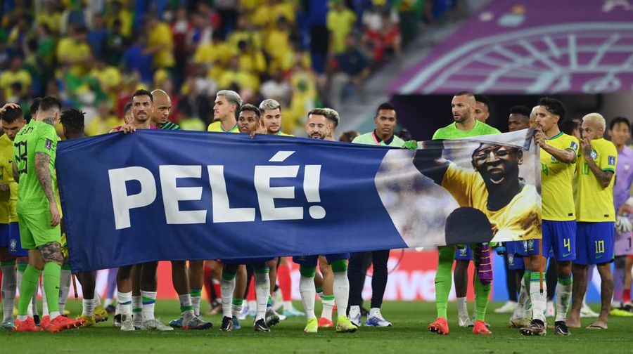Soccer Football - FIFA World Cup Qatar 2022 - Round of 16 - Brazil v South Korea - Stadium 974, Doha, Qatar - December 5, 2022 Brazil players hold a banner of former Brazil player Pele after the match REUTERS/Annegret Hilse