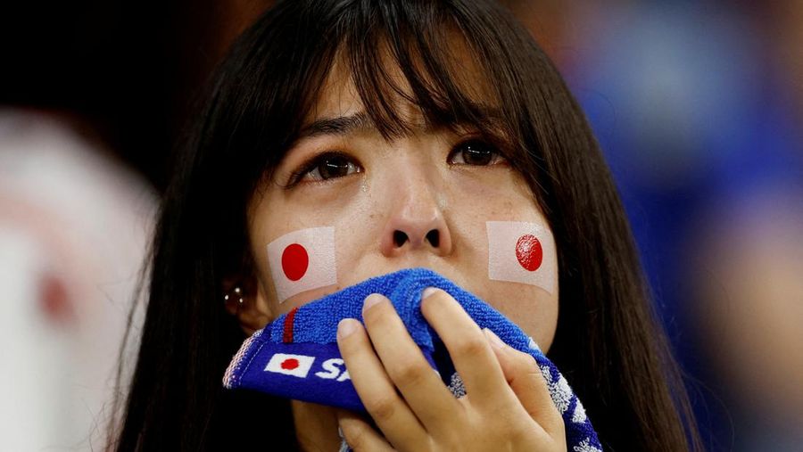 AL WAKRAH, QATAR - DECEMBER 05: A Japanese fan uses his sponge nose to dab tears from his eyes during the FIFA World Cup Qatar 2022 Round of 16 match between Japan and Croatia at Al Janoub Stadium on December 5, 2022 in Al Wakrah, Qatar. (Photo by Charlotte Wilson/Offside/Offside via Getty Images)