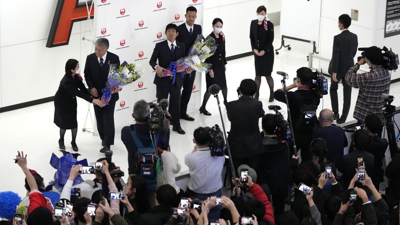 Supporters take photos of the Japanese national soccer team, including head coach Hajime Moriyasu, returning from the World Cup in Qatar at Narita International Airport in Narita, east of Tokyo Japan December 7, 2022. Mandatory credit Kyodo/via REUTERS ATTENTION EDITORS - THIS IMAGE WAS PROVIDED BY A THIRD PARTY. MANDATORY CREDIT. JAPAN OUT. NO COMMERCIAL OR EDITORIAL SALES IN JAPAN