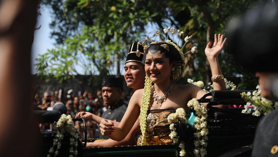 Pasangan pengantin baru Kaesang Pangarep dan Erina Gudono menjalani upacara kirab menggunakan kereta kencana di sepanjang Jalan Slamet Riyadi, Solo, Minggu (11/12/2022). (CNBC Indonesia/ Muhammad Sabki)