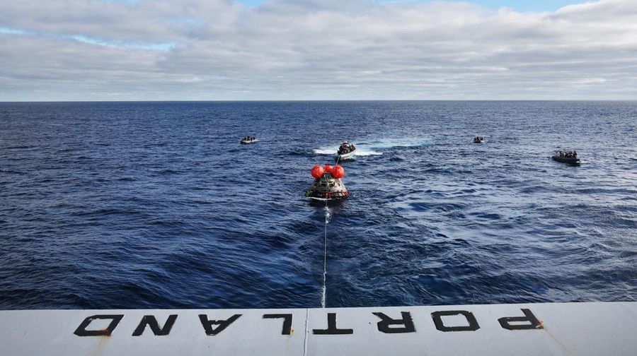 Kapsul Orion NASA berjalan menuju USS Portland (LPD 27) setelah berhasil diamankan oleh tim NASA dan Angkatan Laut AS di lepas pantai Baja California, Meksiko, pada 11 Desember 2022. - Orion diluncurkan 16 November dengan roket Artemis untuk misi 25 hari ke Bulan. Tujuan utama dari misi ini adalah untuk menguji pelindung panas Orion apa cocok untuk manusia berada di dalamnya. (CAROLINE BREHMAN/POOL/AFP via Getty Images)