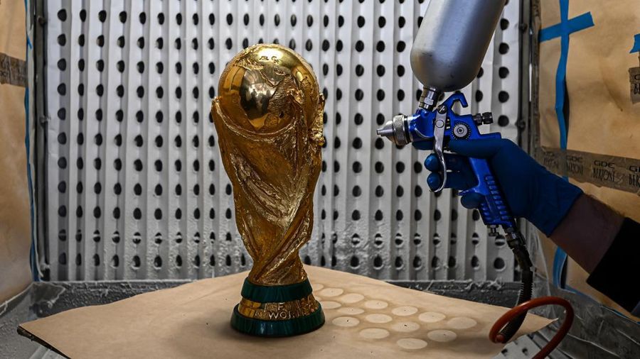 MILAN, ITALY - NOVEMBER 21: A personnel works on a World Cup trophy at the GDE Bertoni headquarters in Milan, Italy on November 21, 2022. GDE Bertoni headquarters is a small building situated in the industrial area of Paderno Dugnano, a town on the outskirts of Milan, northern Italy. It has two floors of offices and workshops and a dozen employees. The company is one of the tens of thousands of small and medium enterprises that make up the backbone of the Italian economy and contribute to making it one of the most prosperous in the world. But it is here that one of the most iconic objects on the planet has been produced for the past 50 years: the World Cup trophy. (Photo by Piero Cruciatti/Anadolu Agency via Getty Images)