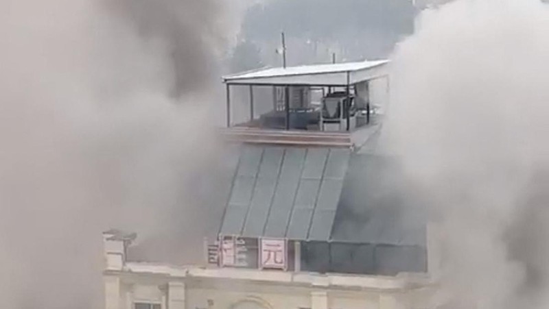 A person prepares to jump from a hotel window in Shahr-e-Naw neighborhood amid sounds of gunfire in Kabul, Afghanistan December 12, 2022 in this still image from video. Aamaj News via REUTERS  THIS IMAGE HAS BEEN SUPPLIED BY A THIRD PARTY. NO RESALES. NO ARCHIVES. MANDATORY CREDIT