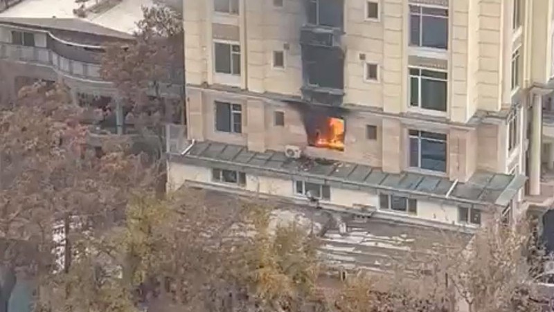 A person prepares to jump from a hotel window in Shahr-e-Naw neighborhood amid sounds of gunfire in Kabul, Afghanistan December 12, 2022 in this still image from video. Aamaj News via REUTERS  THIS IMAGE HAS BEEN SUPPLIED BY A THIRD PARTY. NO RESALES. NO ARCHIVES. MANDATORY CREDIT