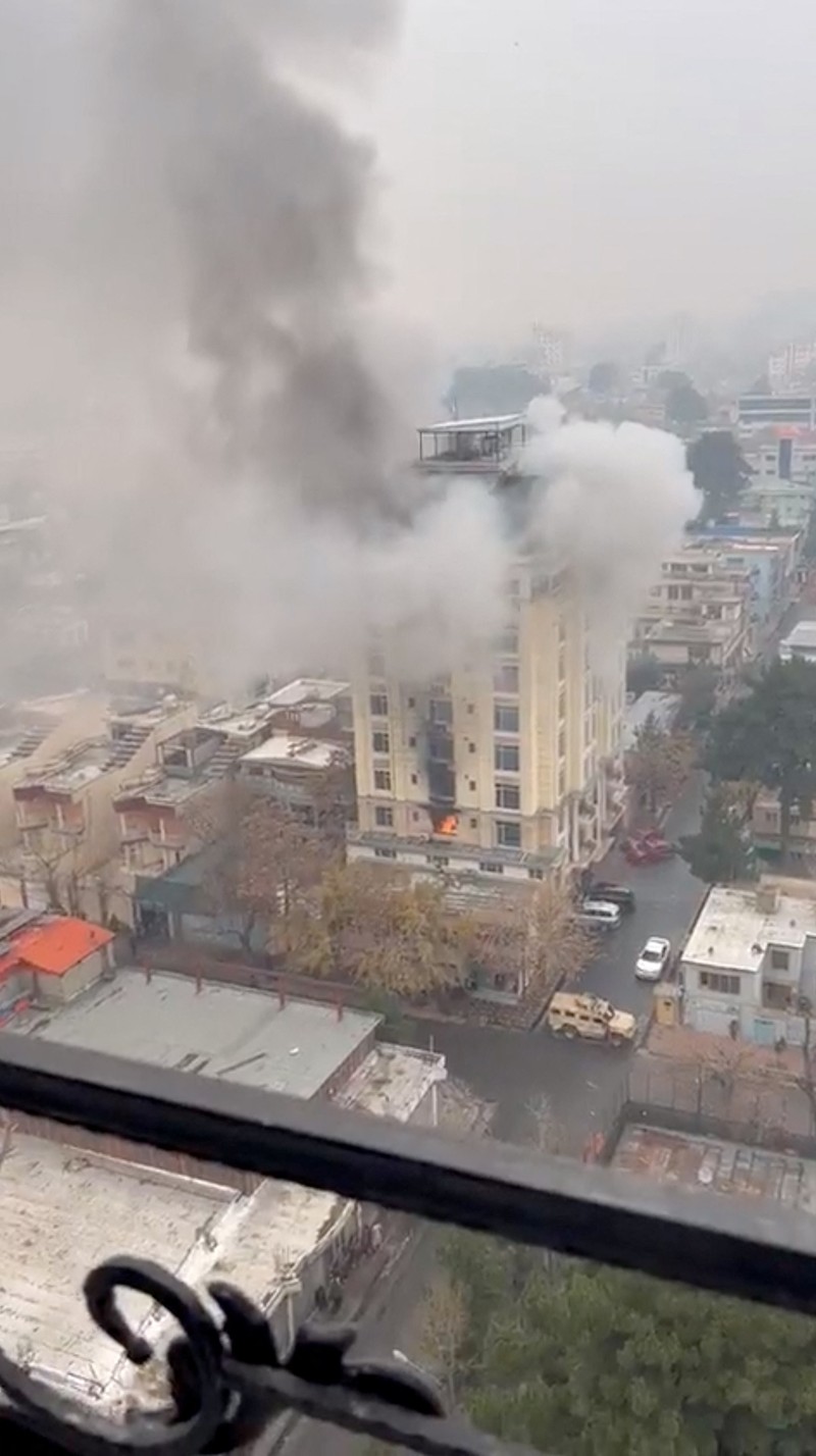 AFGHANISTAN-SHOOTING/UGC A person prepares to jump from a hotel window in Shahr-e-Naw neighborhood amid sounds of gunfire in Kabul, Afghanistan December 12, 2022 in this still image from video. Aamaj News via REUTERS THIS IMAGE HAS BEEN SUPPLIED BY A THIRD PARTY. NO RESALES. NO ARCHIVES. MANDATORY CREDIT