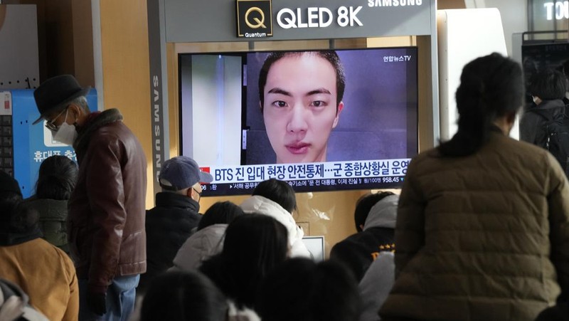 Fans wait for K-pop band BTS's member Jin to arrive before he enters the army to serve near an army training center in Yeoncheon, South Korea, Tuesday, Dec. 13, 2022. Jin, the oldest member of K-pop supergroup BTS, was set to enter a frontline South Korean boot camp Tuesday to start his 18 months of mandatory military service, as fans gathered near the base to say goodbye to their star. (AP Photo/Ahn Young-joon)
