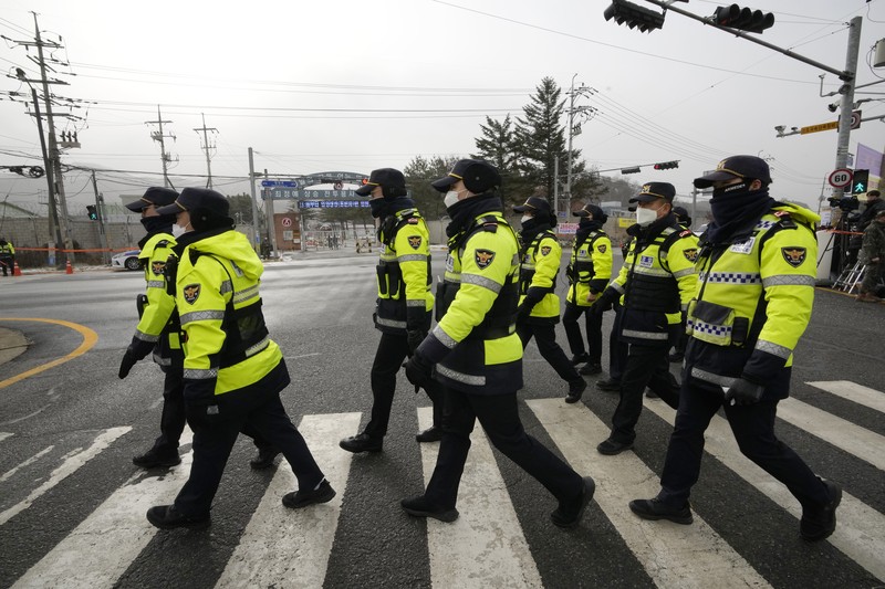 Fans wait for K-pop band BTS's member Jin to arrive before he enters the army to serve near an army training center in Yeoncheon, South Korea, Tuesday, Dec. 13, 2022. Jin, the oldest member of K-pop supergroup BTS, was set to enter a frontline South Korean boot camp Tuesday to start his 18 months of mandatory military service, as fans gathered near the base to say goodbye to their star. (AP Photo/Ahn Young-joon)