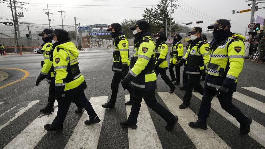 Fans wait for K-pop band BTS's member Jin to arrive before he enters the army to serve near an army training center in Yeoncheon, South Korea, Tuesday, Dec. 13, 2022. Jin, the oldest member of K-pop supergroup BTS, was set to enter a frontline South Korean boot camp Tuesday to start his 18 months of mandatory military service, as fans gathered near the base to say goodbye to their star. (AP Photo/Ahn Young-joon)