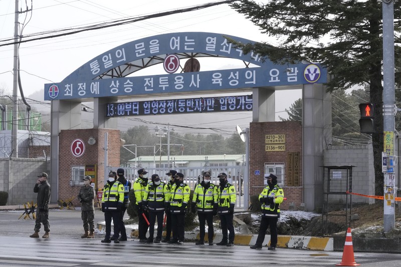 Fans wait for K-pop band BTS's member Jin to arrive before he enters the army to serve near an army training center in Yeoncheon, South Korea, Tuesday, Dec. 13, 2022. Jin, the oldest member of K-pop supergroup BTS, was set to enter a frontline South Korean boot camp Tuesday to start his 18 months of mandatory military service, as fans gathered near the base to say goodbye to their star. (AP Photo/Ahn Young-joon)