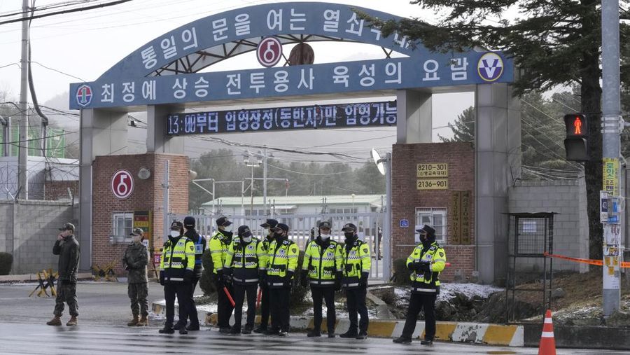 Fans wait for K-pop band BTS's member Jin to arrive before he enters the army to serve near an army training center in Yeoncheon, South Korea, Tuesday, Dec. 13, 2022. Jin, the oldest member of K-pop supergroup BTS, was set to enter a frontline South Korean boot camp Tuesday to start his 18 months of mandatory military service, as fans gathered near the base to say goodbye to their star. (AP Photo/Ahn Young-joon)