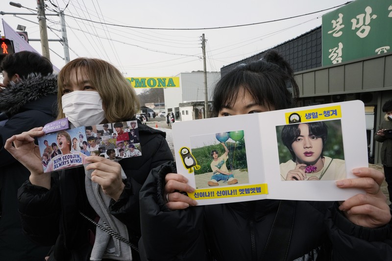 South Koreaa BTS Military Service Fans wait for K-pop band BTS's member Jin to arrive before he enters the army to serve near an army training center in Yeoncheon, South Korea, Tuesday, Dec. 13, 2022. Jin, the oldest member of K-pop supergroup BTS, was set to enter a frontline South Korean boot camp Tuesday to start his 18 months of mandatory military service, as fans gathered near the base to say goodbye to their star. (AP Photo/Ahn Young-joon)
