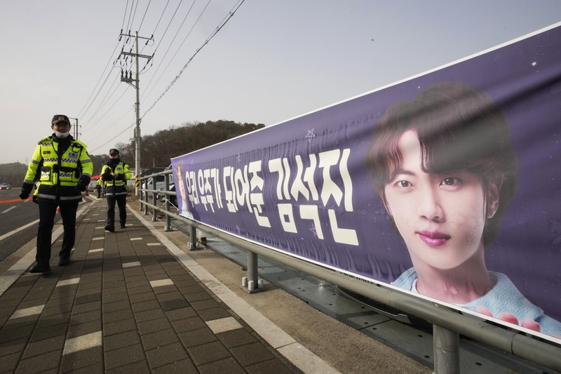 South Koreaa BTS Military Service Fans wait for K-pop band BTS's member Jin to arrive before he enters the army to serve near an army training center in Yeoncheon, South Korea, Tuesday, Dec. 13, 2022. Jin, the oldest member of K-pop supergroup BTS, was set to enter a frontline South Korean boot camp Tuesday to start his 18 months of mandatory military service, as fans gathered near the base to say goodbye to their star. (AP Photo/Ahn Young-joon)