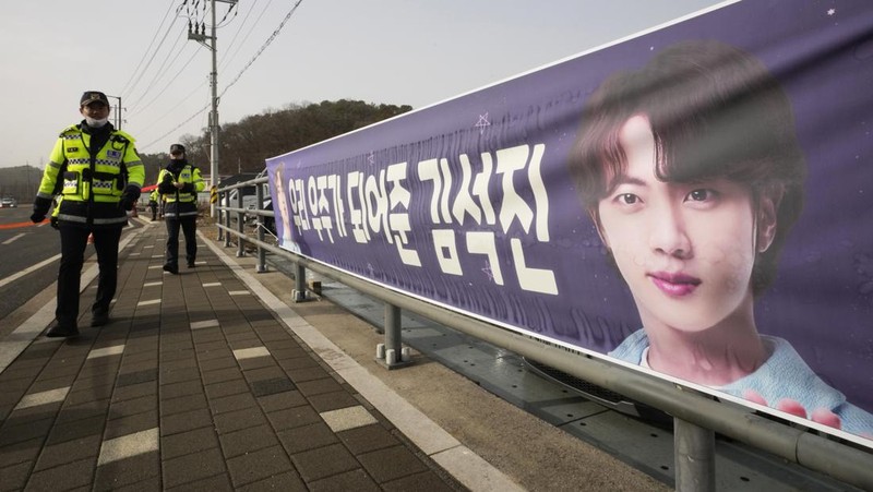 Fans wait for K-pop band BTS's member Jin to arrive before he enters the army to serve near an army training center in Yeoncheon, South Korea, Tuesday, Dec. 13, 2022. Jin, the oldest member of K-pop supergroup BTS, was set to enter a frontline South Korean boot camp Tuesday to start his 18 months of mandatory military service, as fans gathered near the base to say goodbye to their star. (AP Photo/Ahn Young-joon)