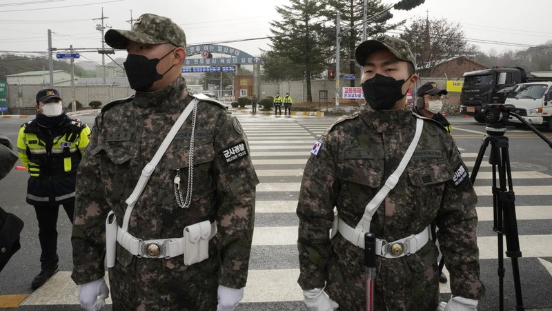 Fans wait for K-pop band BTS's member Jin to arrive before he enters the army to serve near an army training center in Yeoncheon, South Korea, Tuesday, Dec. 13, 2022. Jin, the oldest member of K-pop supergroup BTS, was set to enter a frontline South Korean boot camp Tuesday to start his 18 months of mandatory military service, as fans gathered near the base to say goodbye to their star. (AP Photo/Ahn Young-joon)
