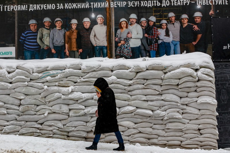 Seorang pria membersihkan salju saat hujan salju di Kyiv, Ukraina pada 15 Desember 2022. (Anadolu Agency via Getty Images)