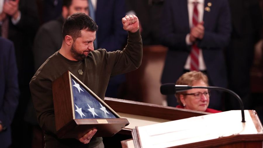 WASHINGTON, DC - DECEMBER 21: President of Ukraine Volodymyr Zelensky holds an American flag gifted to him by U.S. Speaker of the House Nancy Pelosi (D-CA) as he addresses a joint meeting of Congress in the House Chamber of the U.S. Capitol on December 21, 2022 in Washington, DC. In his first known trip outside of Ukraine since Russia invaded, Zelensky met with U.S. President Joe Biden and outlined Ukraine's request for continued military aid. (Photo by Win McNamee/Getty Images)