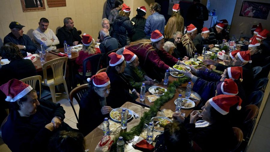 Palestinian eat during community Christmas dinner for elderly residents at the only majority-Christian Palestinian refugee camp, in Dbayeh, north of Beirut, Lebanon, Wednesday, Dec. 21, 2022. Hundreds of thousands of Palestinians fled or were forced from their homes during the 1948 Mideast war over Israel's creation. Today, several million Palestinian refugees and their descendants are scattered across Jordan, Syria and Lebanon, as well as the West Bank and Gaza, lands Israel captured in 1967. (AP Photo/Bilal Hussein)