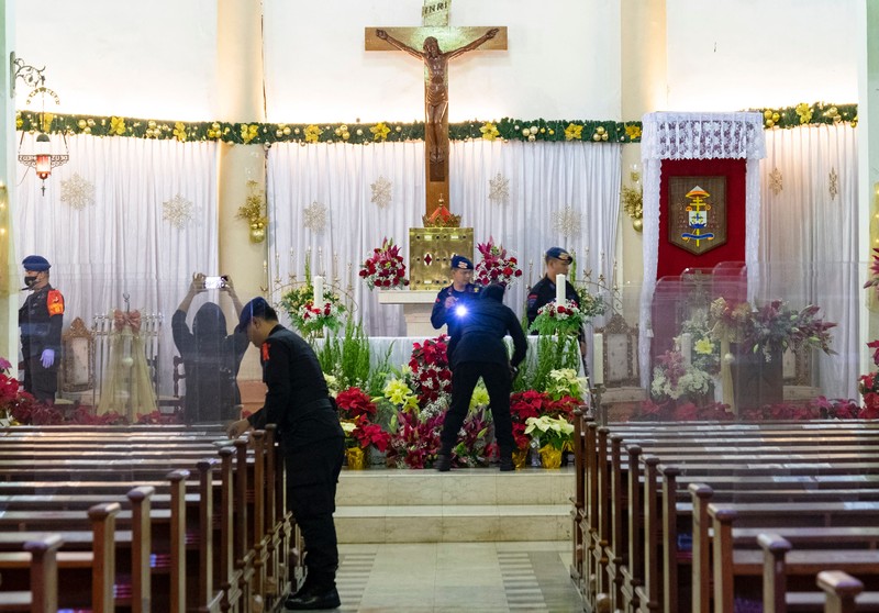 1245808930 Anti-terror police check security at a church ahead of Christmas eve in Medan on December 24, 2022. (Photo by ARIANDI / AFP) (Photo by ARIANDI/AFP via Getty Images)