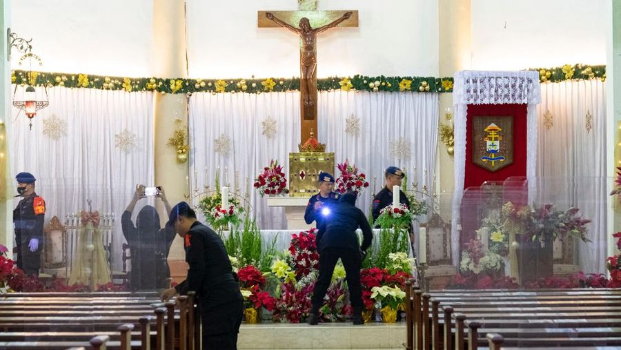Anti-terror police check security at a church ahead of Christmas eve in Medan on December 24, 2022. (Photo by ARIANDI / AFP) (Photo by ARIANDI/AFP via Getty Images)