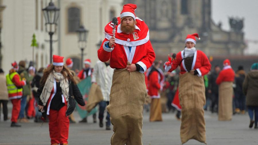Students dressed in Santa Claus costumes take part in a funny sack race challenge in Dresden, Germany, December 3, 2022. REUTERS/Matthias Rietschel