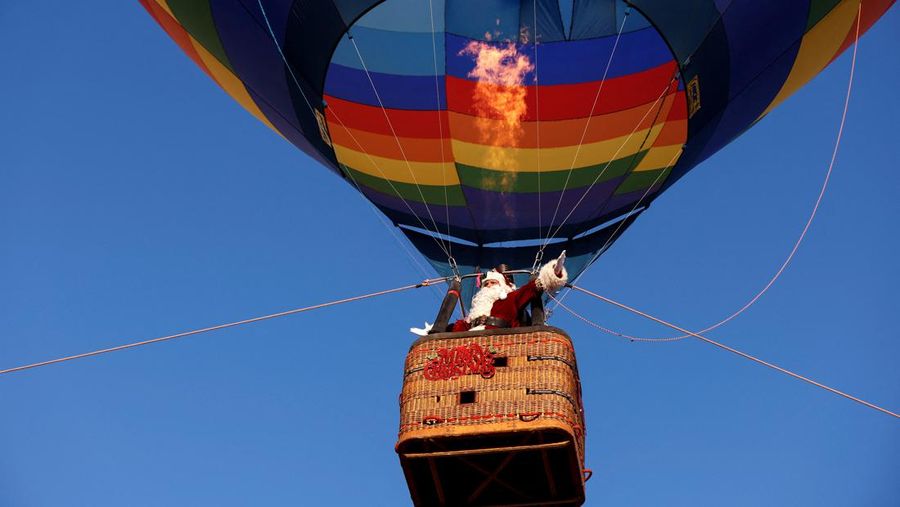 Issa Kassissieh dressed as Santa Claus flies above Jerusalem in a hot air balloon December 20, 2022. REUTERS/Amir Cohen