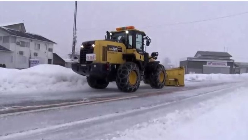 A man clears snow at a parking lot in Kitami, Hokkaido Prefecture, Japan in this photo taken by Kyodo on December 24, 2022.  Mandatory credit Kyodo/via REUTERS ATTENTION EDITORS - THIS IMAGE WAS PROVIDED BY A THIRD PARTY. MANDATORY CREDIT. JAPAN OUT. NO COMMERCIAL OR EDITORIAL SALES IN JAPAN
