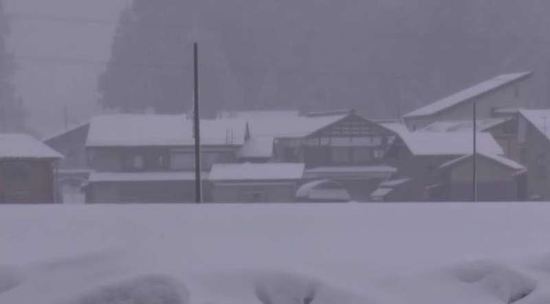 JAPAN-SNOW/ A man clears snow at a parking lot in Kitami, Hokkaido Prefecture, Japan in this photo taken by Kyodo on December 24, 2022. Mandatory credit Kyodo/via REUTERS ATTENTION EDITORS - THIS IMAGE WAS PROVIDED BY A THIRD PARTY. MANDATORY CREDIT. JAPAN OUT. NO COMMERCIAL OR EDITORIAL SALES IN JAPAN