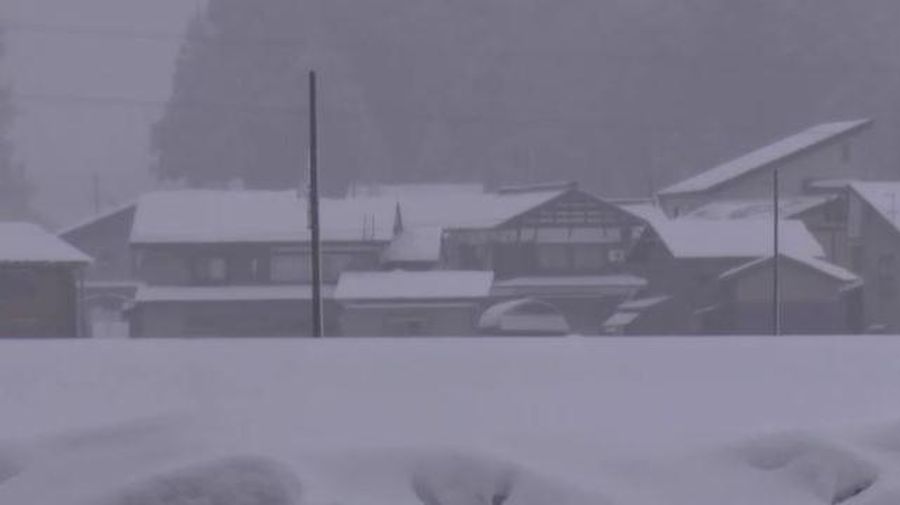 A man clears snow at a parking lot in Kitami, Hokkaido Prefecture, Japan in this photo taken by Kyodo on December 24, 2022.  Mandatory credit Kyodo/via REUTERS ATTENTION EDITORS - THIS IMAGE WAS PROVIDED BY A THIRD PARTY. MANDATORY CREDIT. JAPAN OUT. NO COMMERCIAL OR EDITORIAL SALES IN JAPAN